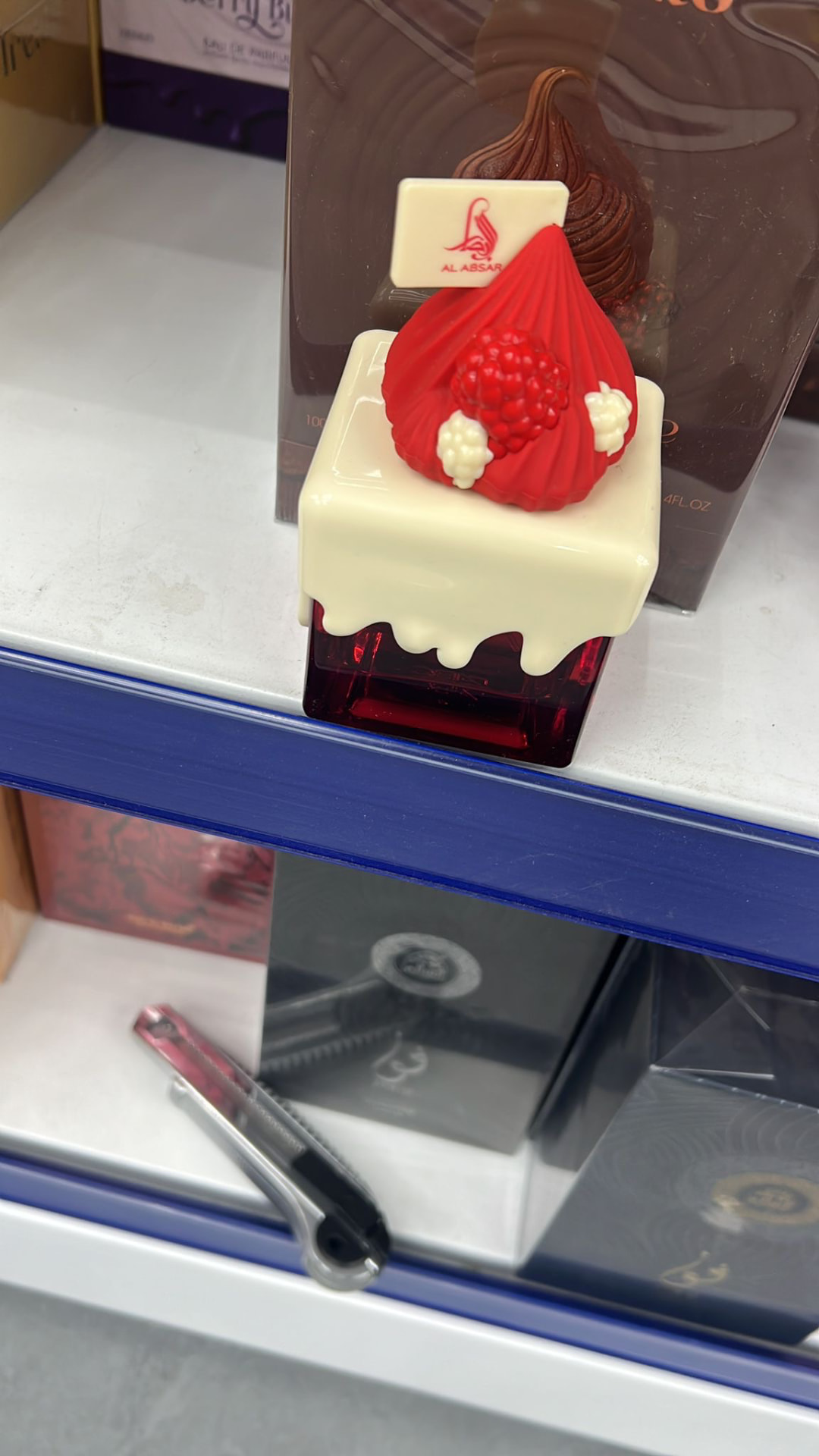 Al Absar dessert-inspired perfume in a red and white bottle